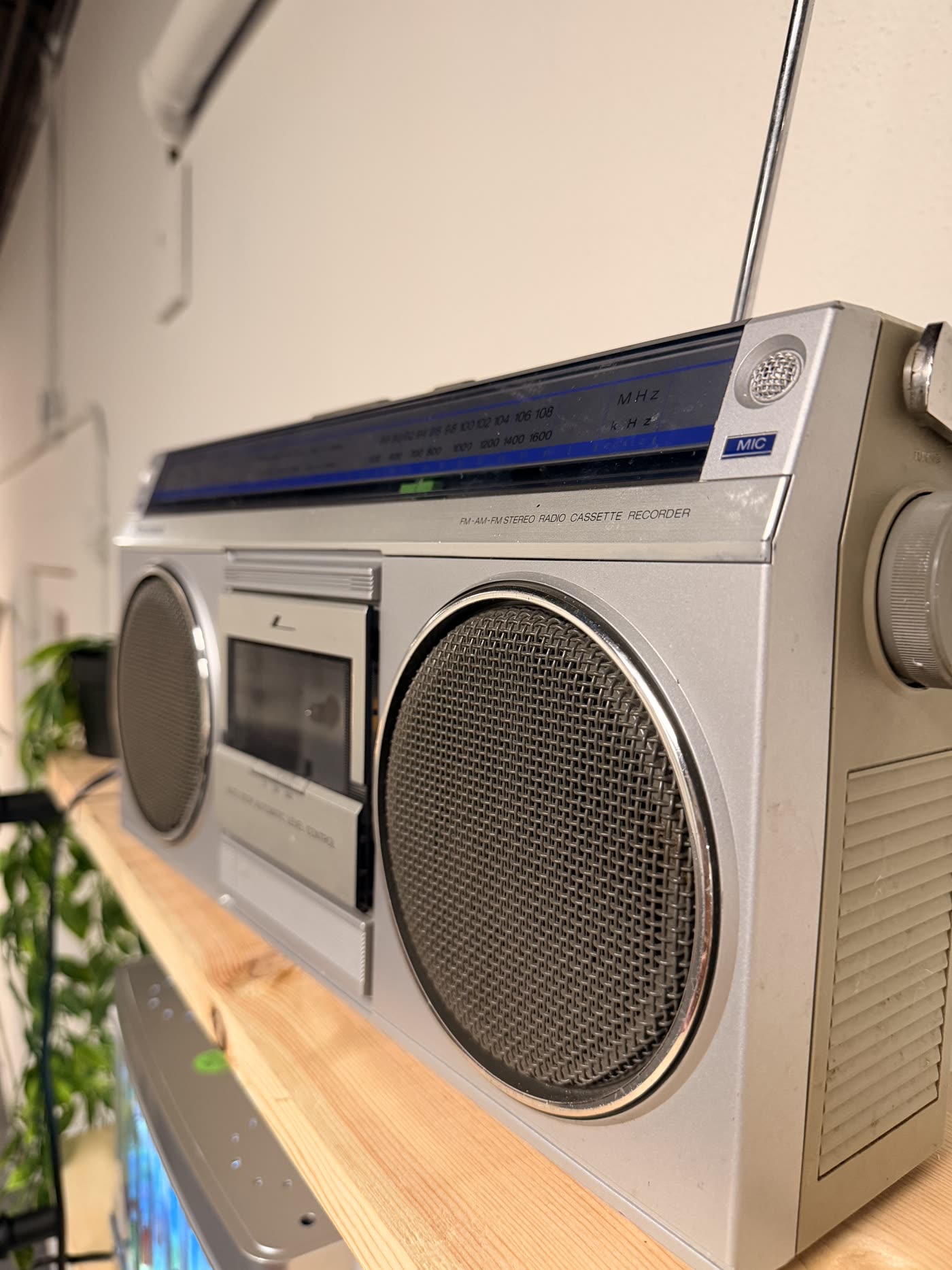 Vintage silver boombox displayed on a shelf at Nine99