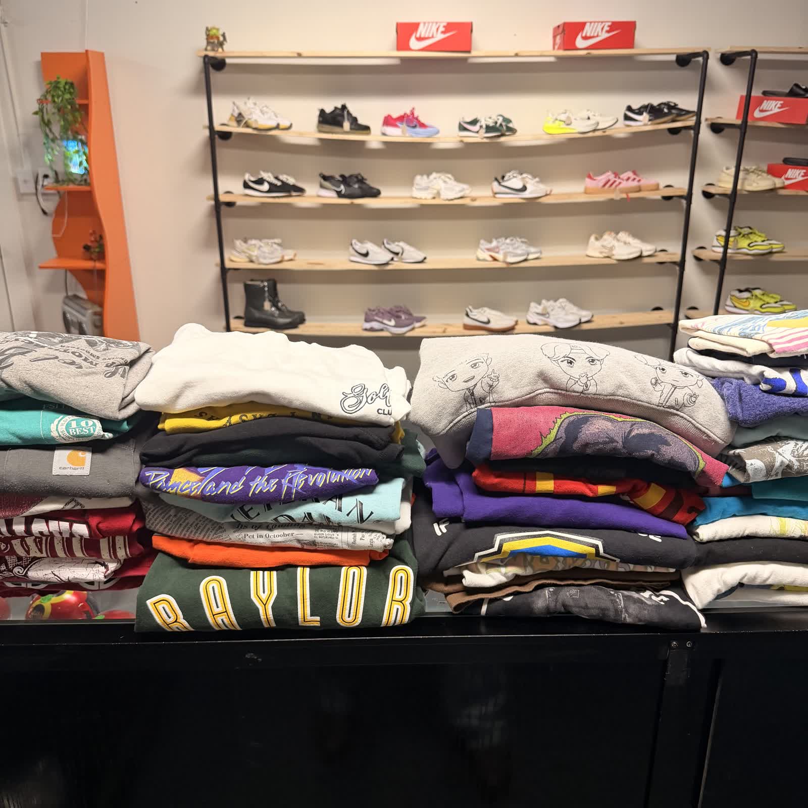 Fresh drop of folded vintage tees and hoodies stacked at Nine99