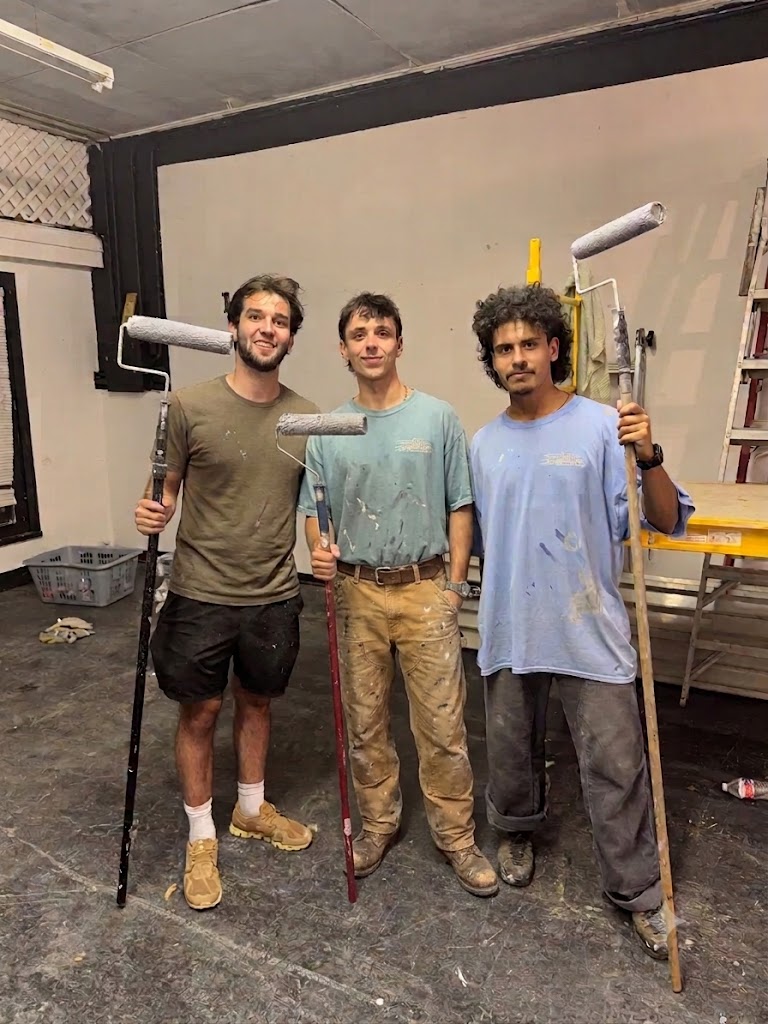 Nine99 founders Josh, Harlan, and Hector with paint rollers building the store