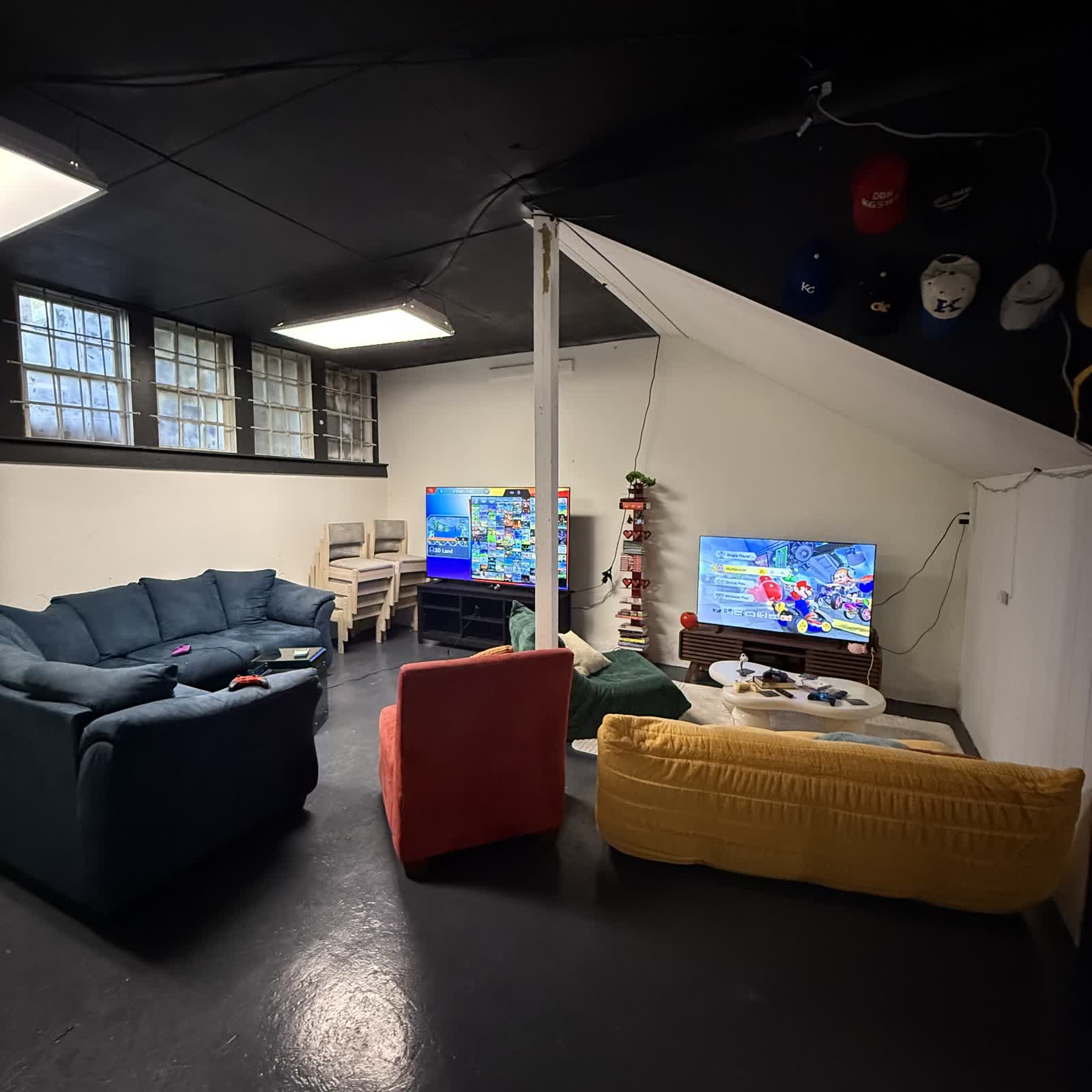 The Nine99 game lounge area with couches and retro consoles