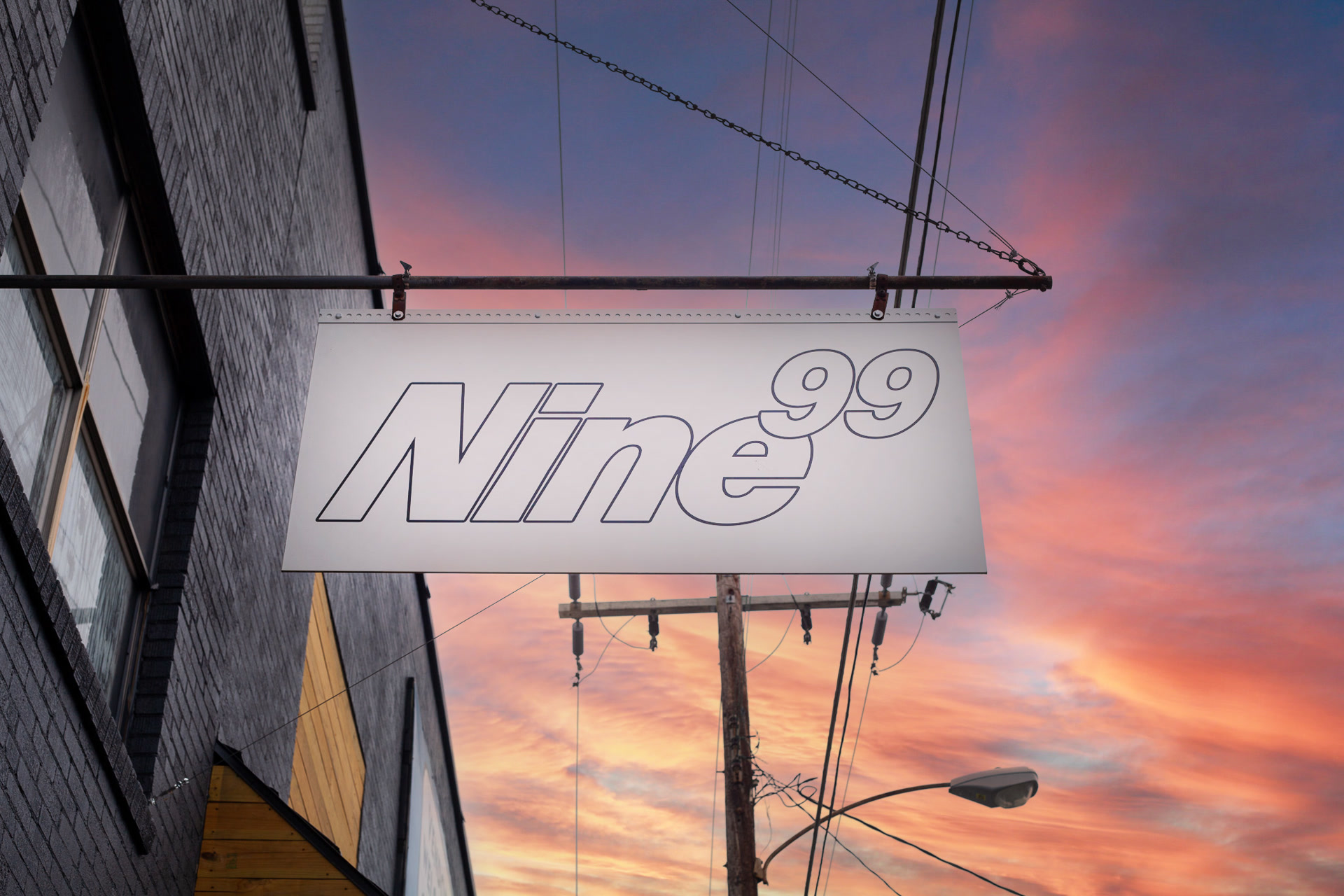 Nine99 store sign glowing against a Hot Springs sunset