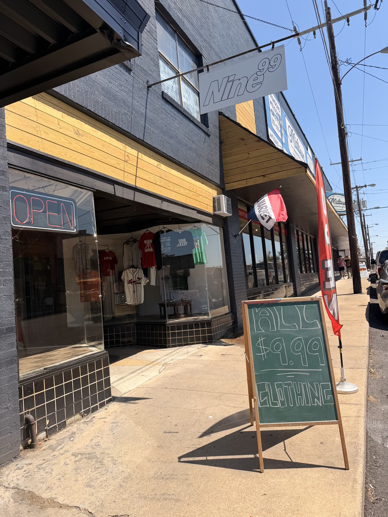 Nine99 store entrance — open sign and sidewalk chalkboard